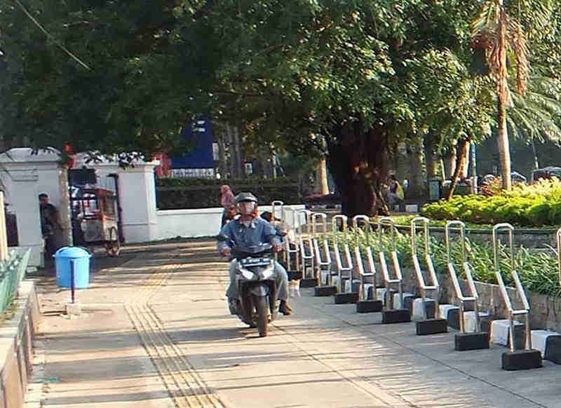 Motorcyclist on Sidewalk
